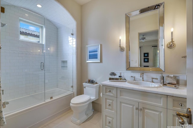 full bathroom with vanity, tile patterned floors, combined bath / shower with glass door, and toilet