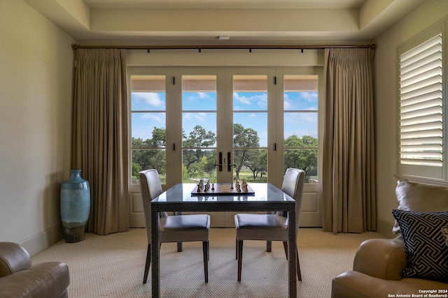 dining space with french doors, light colored carpet, and plenty of natural light