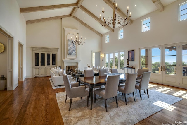 dining room featuring beam ceiling, hardwood / wood-style flooring, french doors, and a chandelier