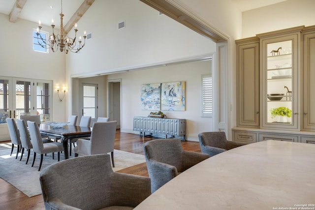 dining room with french doors, high vaulted ceiling, a notable chandelier, beam ceiling, and hardwood / wood-style floors