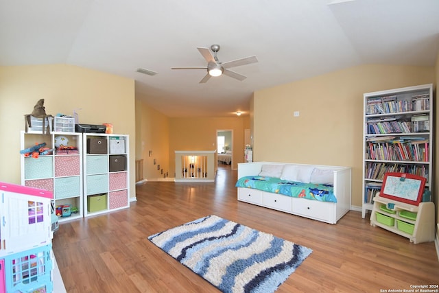 living area with hardwood / wood-style flooring, ceiling fan, and lofted ceiling