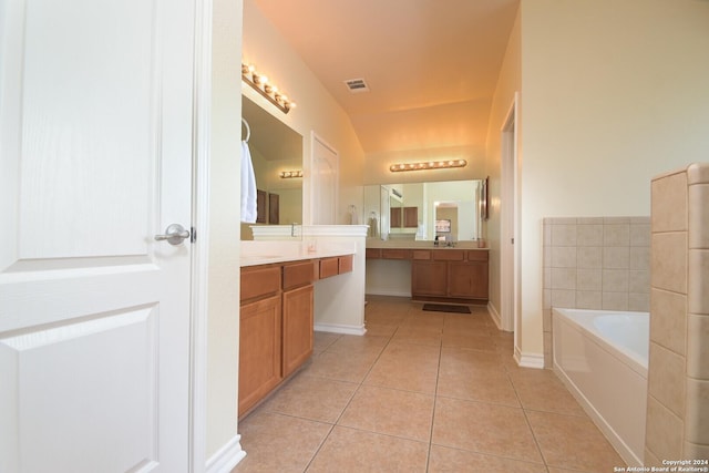 bathroom with vanity, tile patterned floors, and a tub