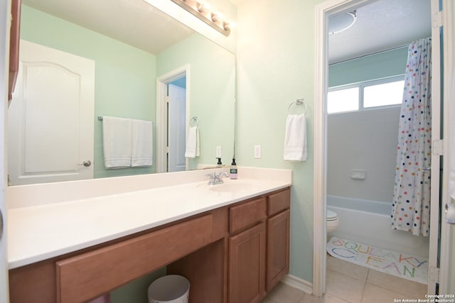 full bathroom with tile patterned flooring, shower / bath combination with curtain, toilet, and vanity