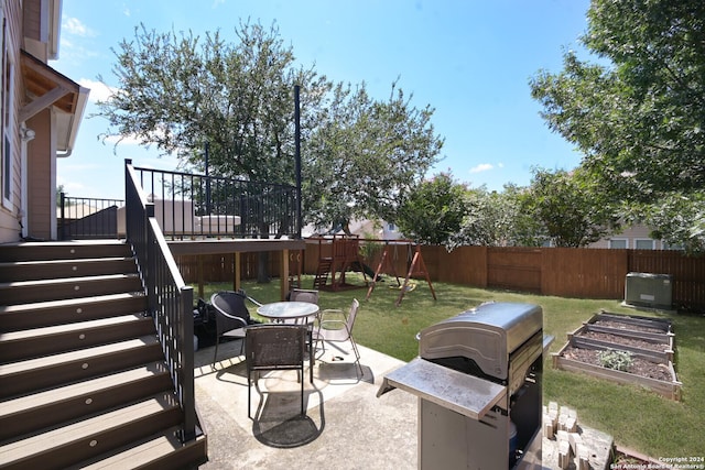 view of patio / terrace with a grill, a fenced backyard, a vegetable garden, and stairway