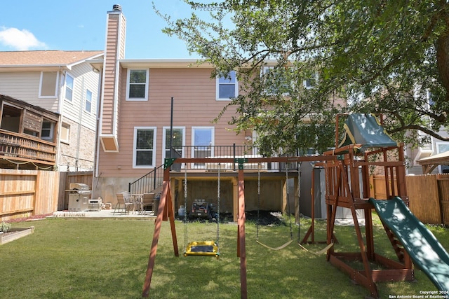 view of playground with a yard, a patio area, and fence