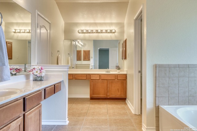 full bathroom featuring a sink, two vanities, tile patterned flooring, and a bath