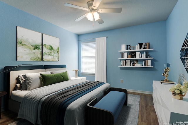 bedroom with wood finished floors, a ceiling fan, and baseboards