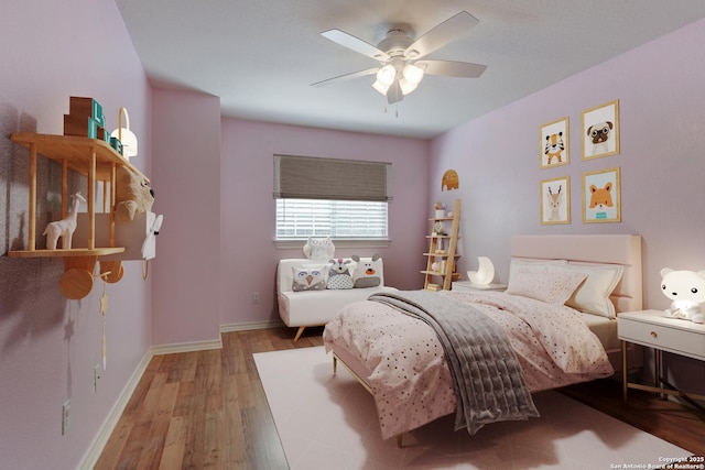 bedroom featuring wood finished floors, a ceiling fan, and baseboards