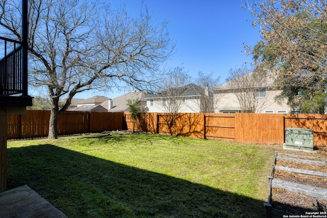 view of yard with a fenced backyard