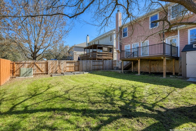 view of yard featuring a storage unit, an outdoor structure, and a fenced backyard