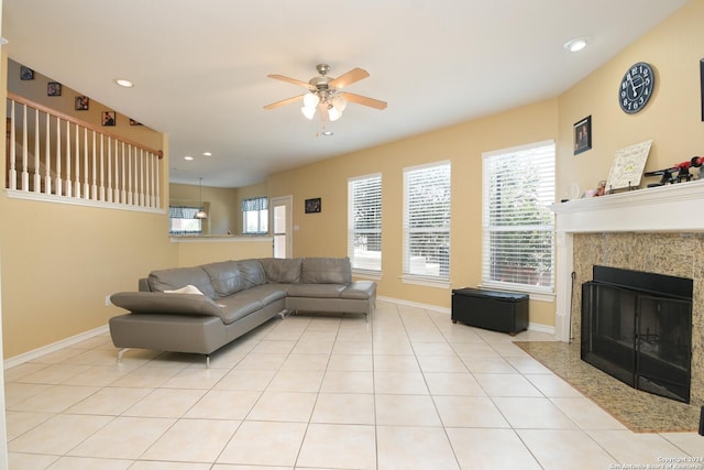 living area featuring light tile patterned floors, ceiling fan, recessed lighting, a fireplace with flush hearth, and baseboards