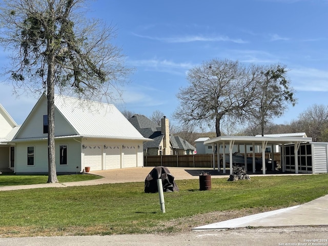 view of property's community featuring a lawn and a garage