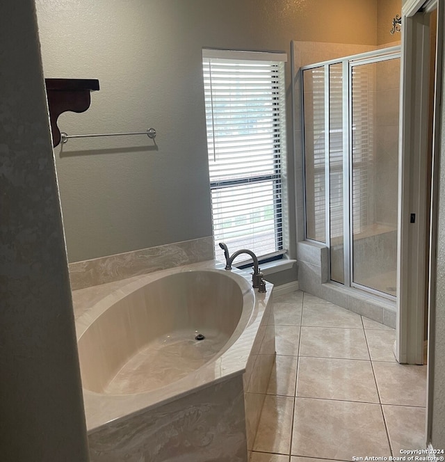 bathroom with tile patterned floors and independent shower and bath