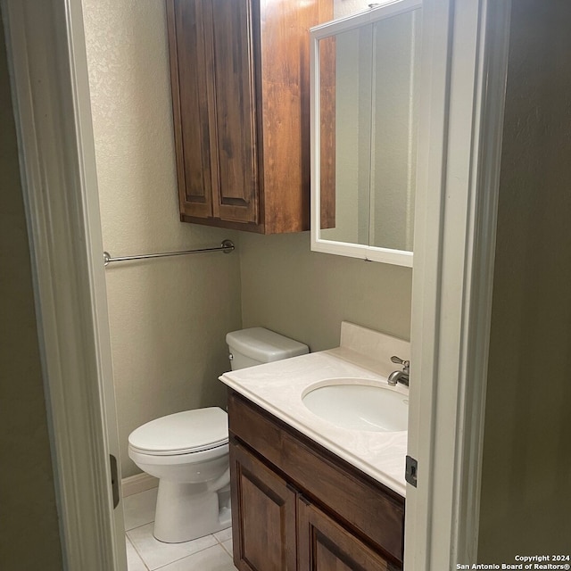 bathroom featuring tile patterned flooring, vanity, and toilet