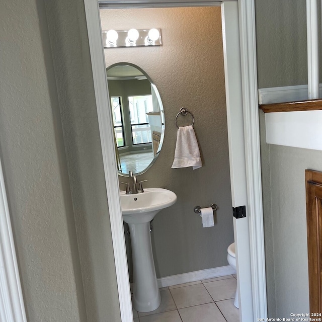 bathroom featuring tile patterned flooring, toilet, and sink