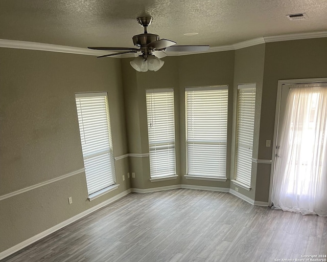 unfurnished room with ceiling fan, plenty of natural light, and light hardwood / wood-style floors