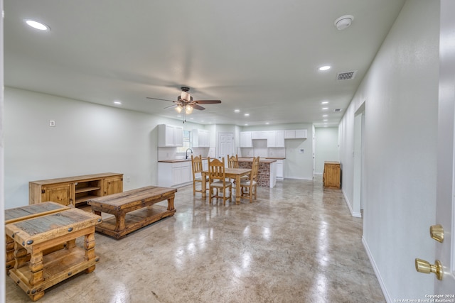 living room with ceiling fan and sink