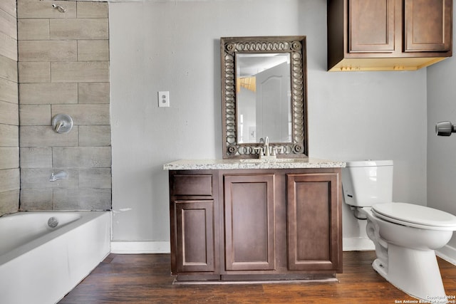 full bathroom with vanity, tiled shower / bath combo, hardwood / wood-style flooring, and toilet