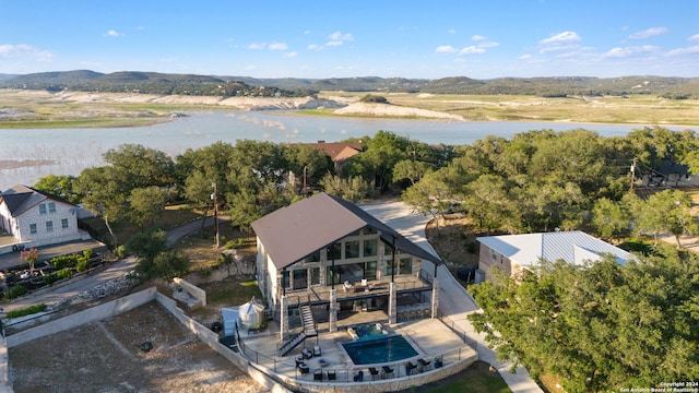 birds eye view of property with a water and mountain view