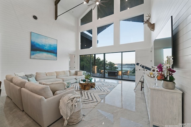 living room with beam ceiling and high vaulted ceiling