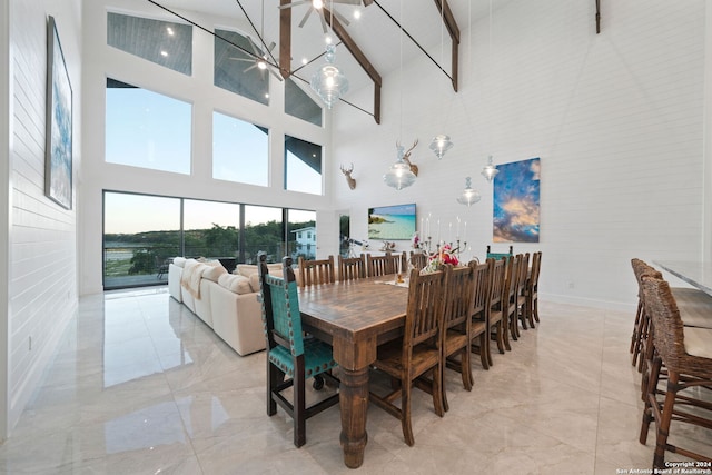 dining space featuring a healthy amount of sunlight and high vaulted ceiling