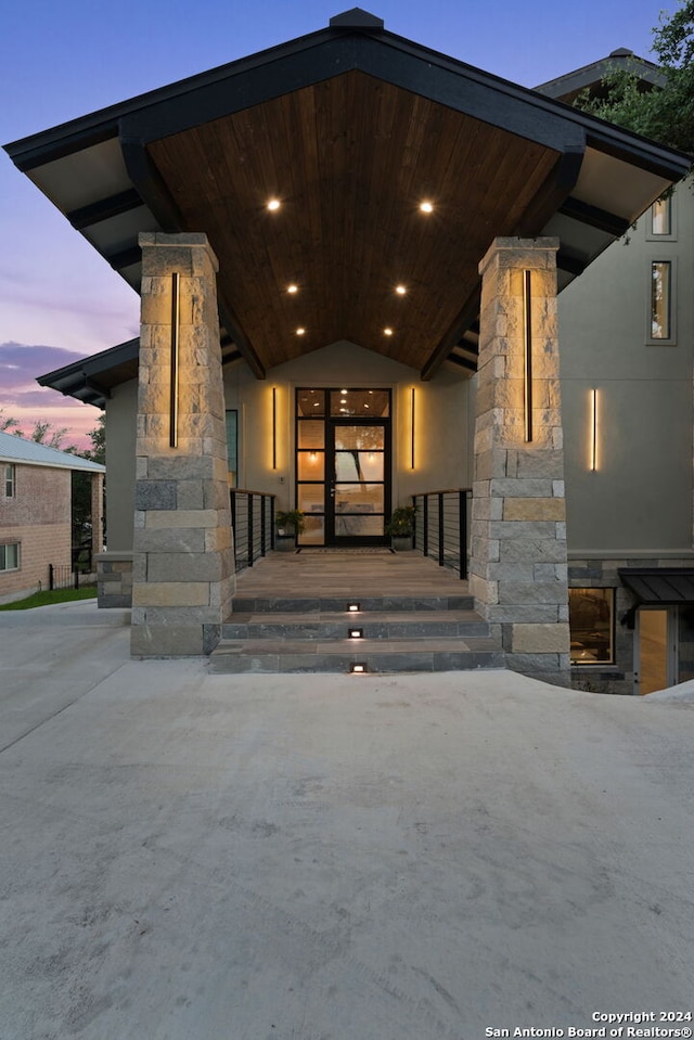 exterior entry at dusk with covered porch