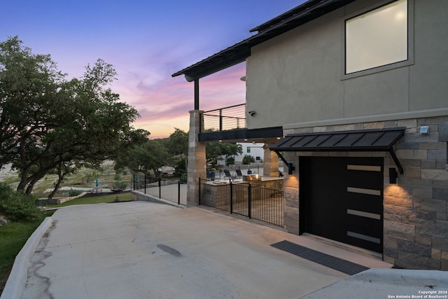 patio terrace at dusk with a balcony