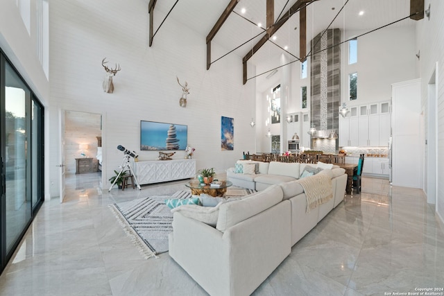 living room featuring plenty of natural light and high vaulted ceiling