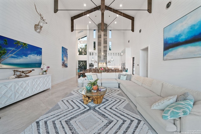 living room featuring beamed ceiling and high vaulted ceiling