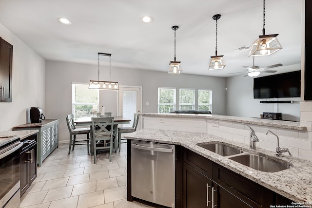 kitchen featuring sink, dishwasher, a healthy amount of sunlight, and decorative light fixtures