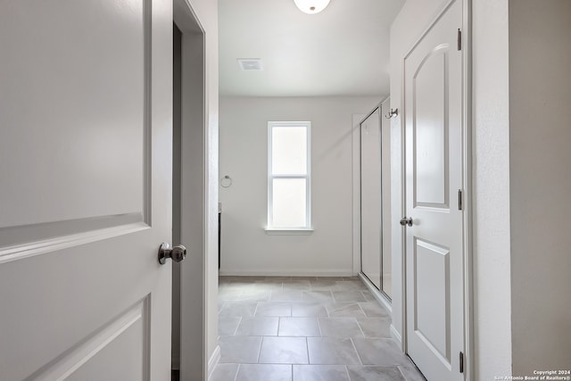 corridor with tile patterned flooring