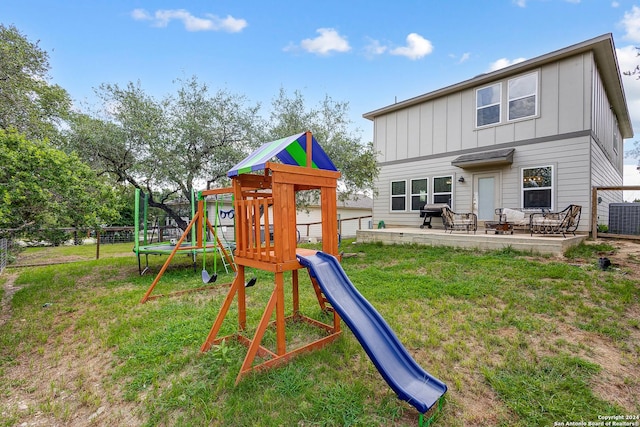 view of jungle gym featuring cooling unit, a patio, and a lawn