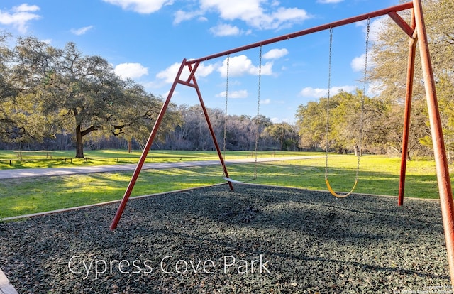 view of playground with a lawn