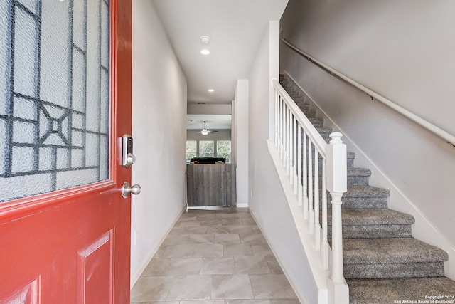 interior space with ceiling fan