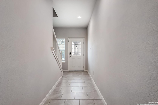 doorway with light tile patterned floors