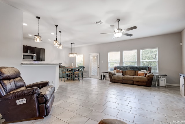 living room featuring ceiling fan and light tile patterned floors