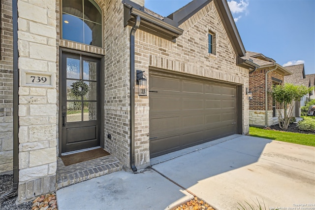 doorway to property featuring a garage