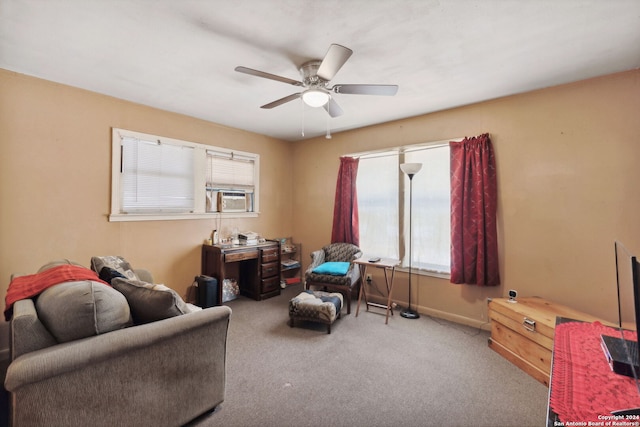 living area with cooling unit, light colored carpet, and ceiling fan