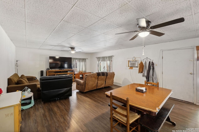 dining space with ceiling fan, dark hardwood / wood-style floors, and a wall unit AC