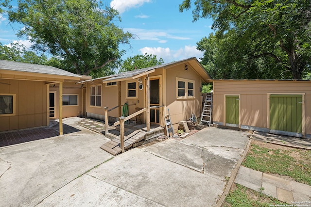 view of front of home featuring an outdoor structure and a patio