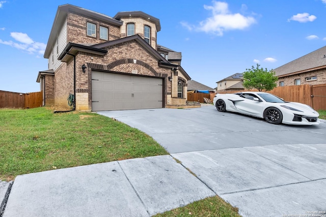 view of front facade with a front lawn and a garage