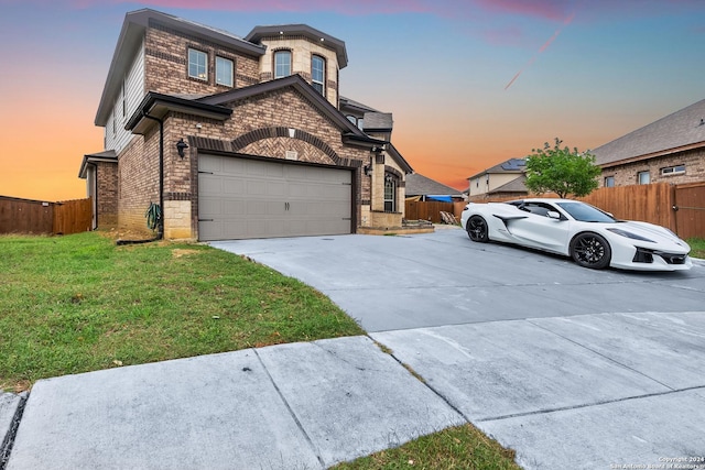 view of front of property featuring a yard and a garage