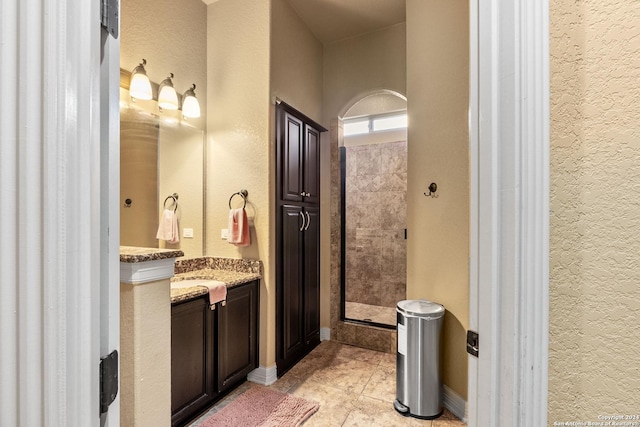 bathroom with tile patterned flooring, vanity, and a shower with shower door