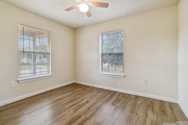 empty room featuring ceiling fan and light wood-type flooring