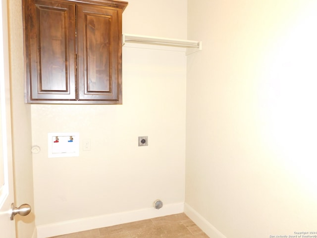 laundry room with washer hookup, electric dryer hookup, cabinets, and light tile floors