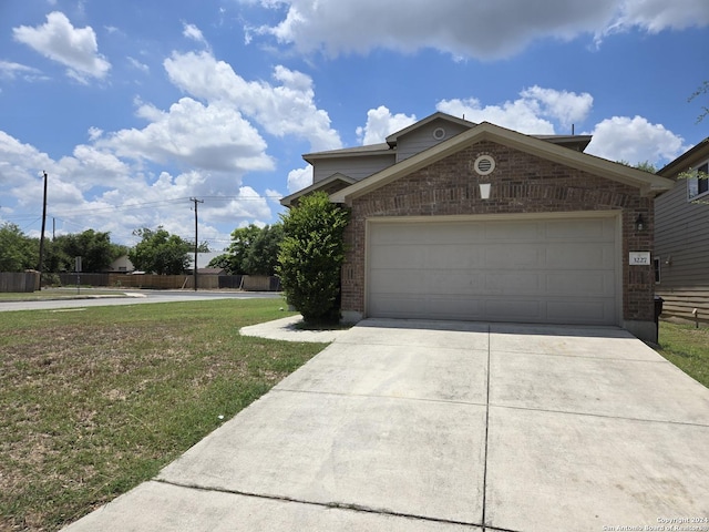 view of front of property with a garage and a front yard