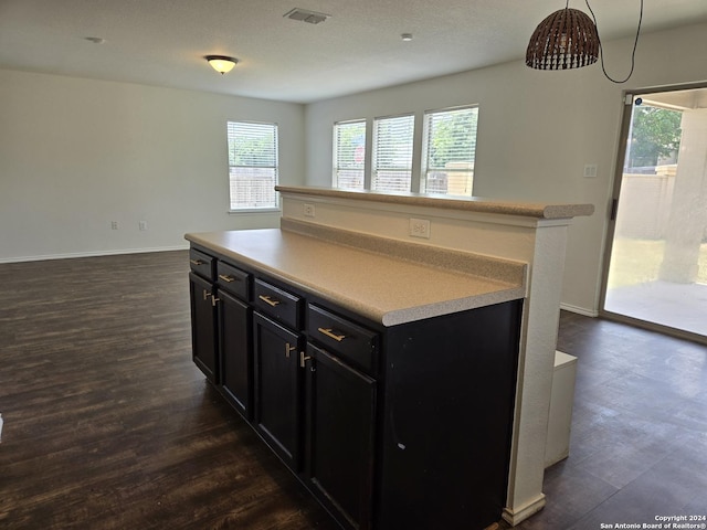 kitchen with pendant lighting, a center island, and dark hardwood / wood-style flooring