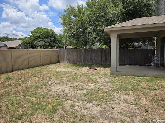 view of yard with a fire pit and a patio