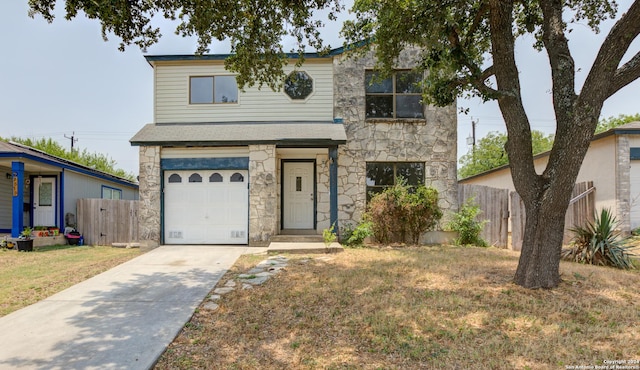 view of front of property with a garage and a front lawn