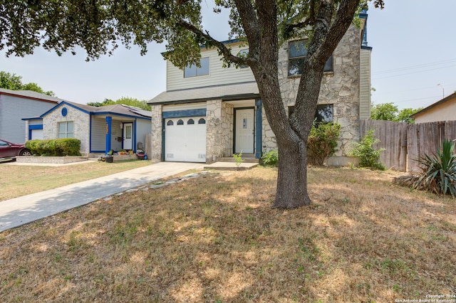 view of front of house with a garage and a front lawn